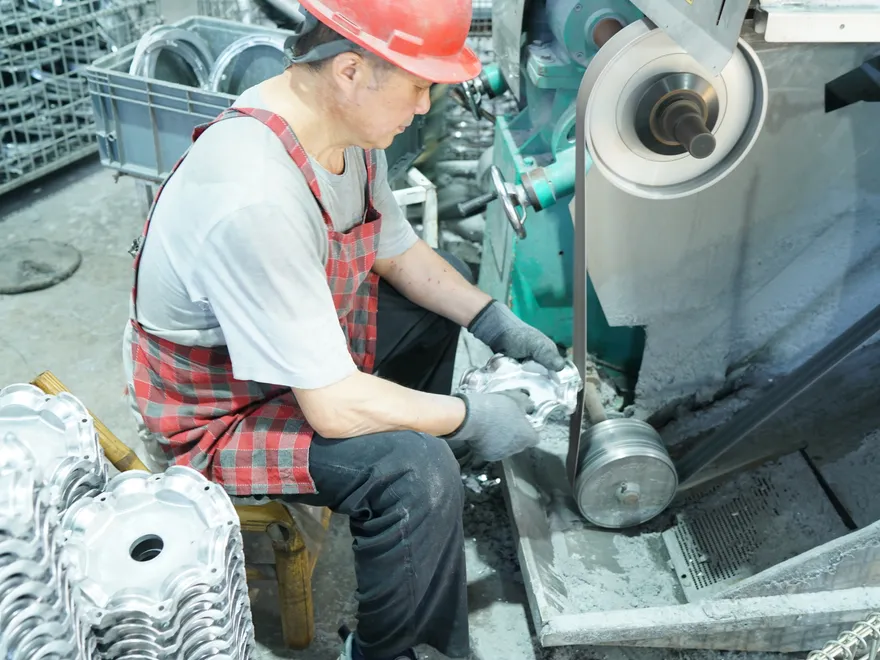 Die-cast aluminum LED housing being deburred and machined after high-pressure casting at Sunjoylight factory