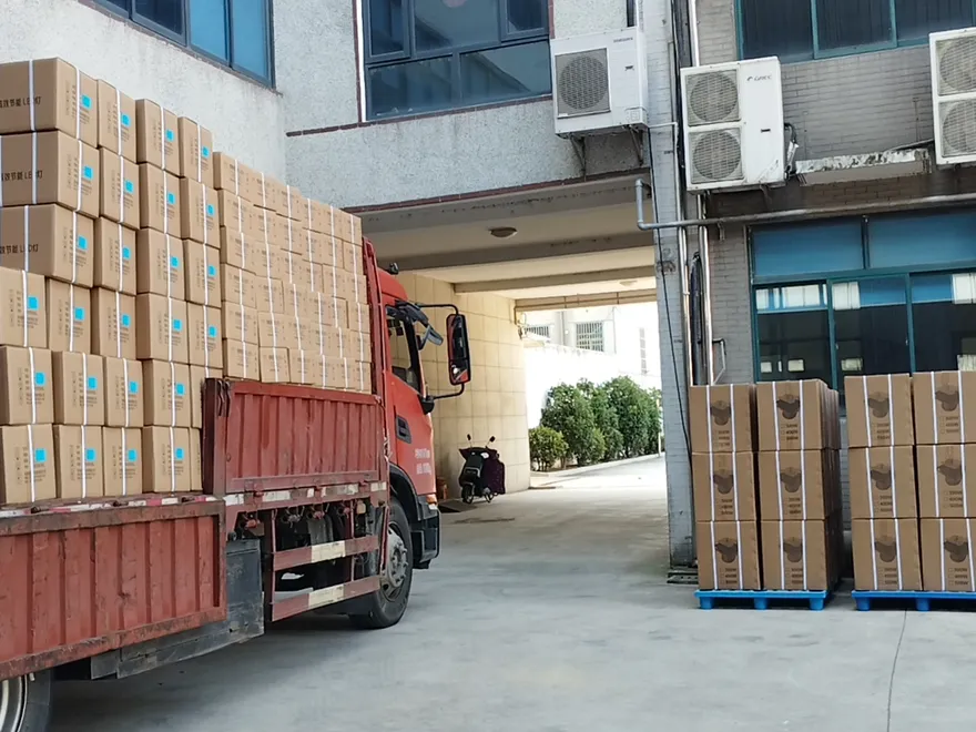 Packed industrial LED luminaires in export cartons being prepared for container loading and international shipment