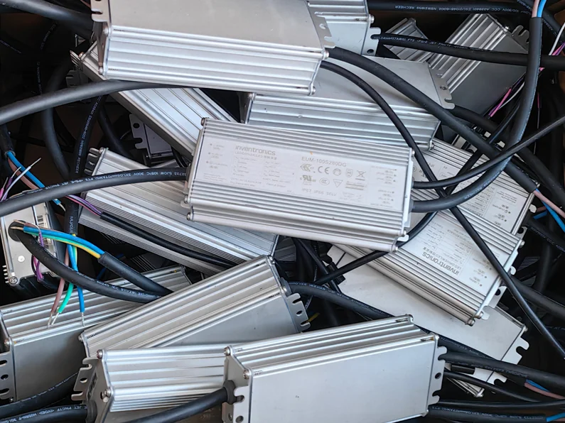 Sealed aluminum-cased constant-current LED drivers for flood lights, the replaceable power units wired for assembly