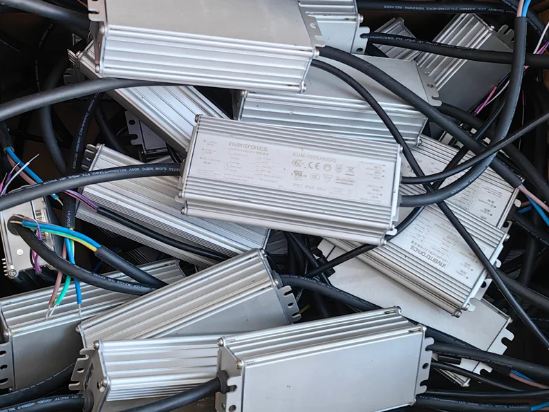 Sealed aluminum-cased constant-current LED drivers for high bay lights, the field-replaceable power units wired for assembly