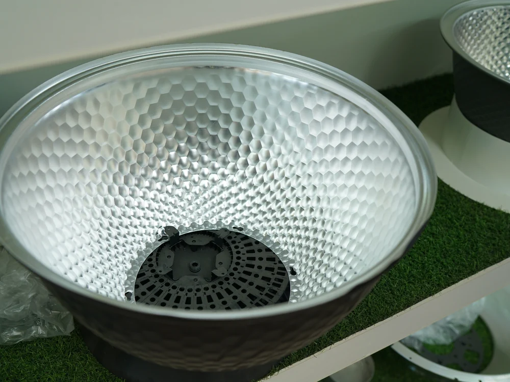 High-purity dimpled aluminum reflector dish for an LED high bay light, the classic reflector optic that spreads light to the floor