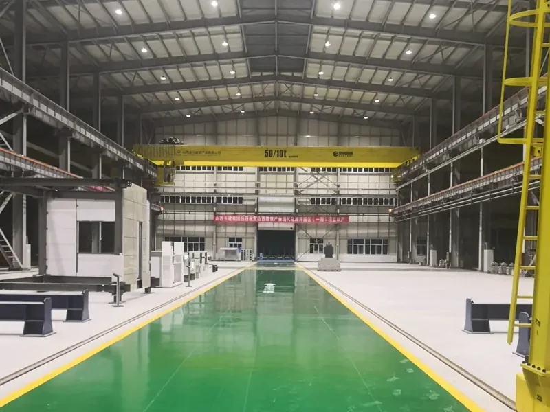 Clean production workshop with an epoxy-coated floor, lit by LED high bay fixtures suspended from the roof frame